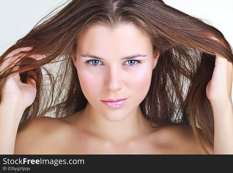 Beautiful woman face closeup on light background