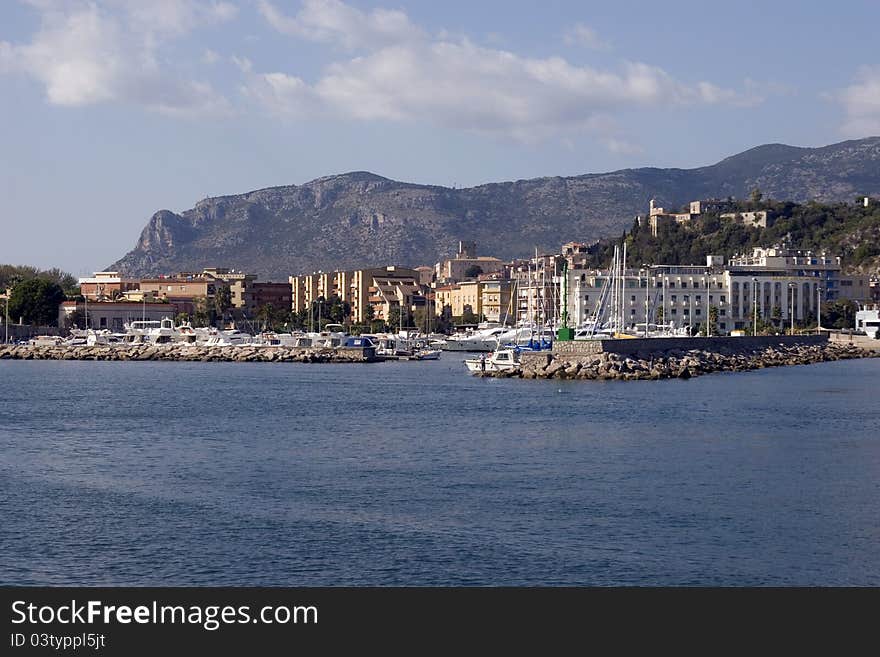 Terracina's port, boats and background mountains.