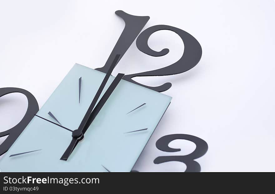 Closeup of a wall clock on white background, one minute to midnight