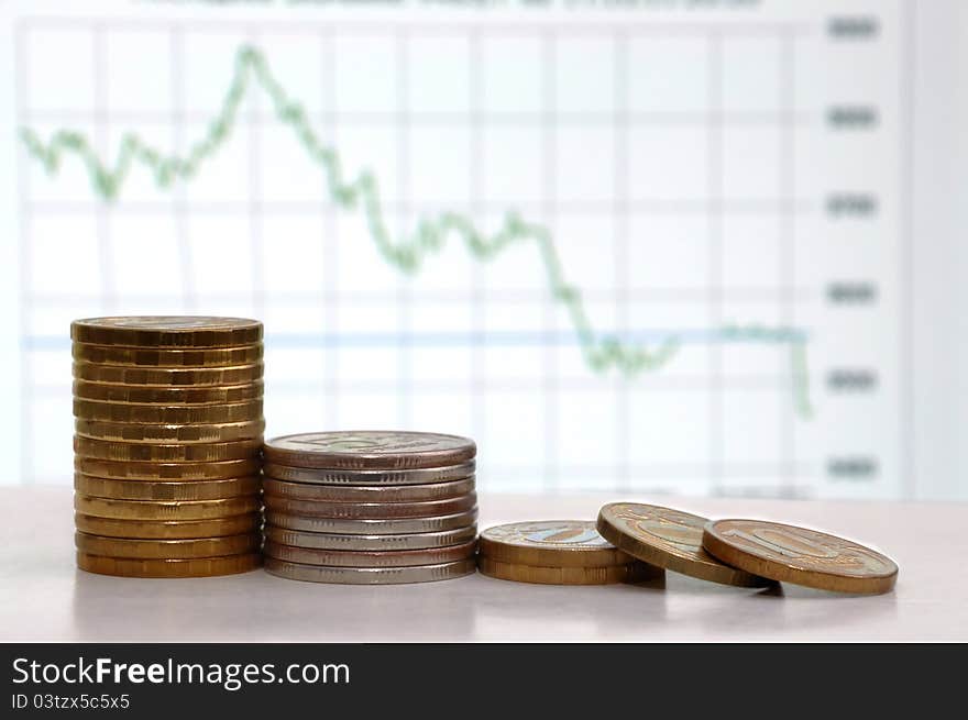 Coins in front of schedule of currency quotations. Coins in front of schedule of currency quotations