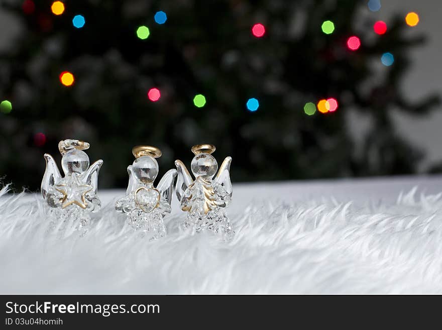 Three Christmas angels decorations on a white fur