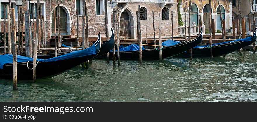 Lined-up Gondola boats moored on one of he canals in Venice. Lined-up Gondola boats moored on one of he canals in Venice.