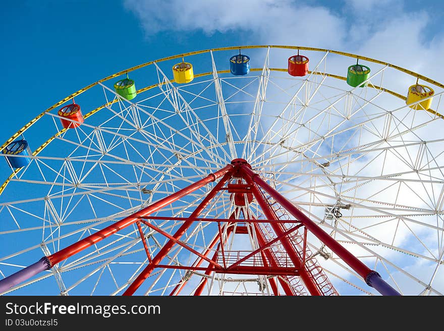 Attraction ferris wheel on blue sky background