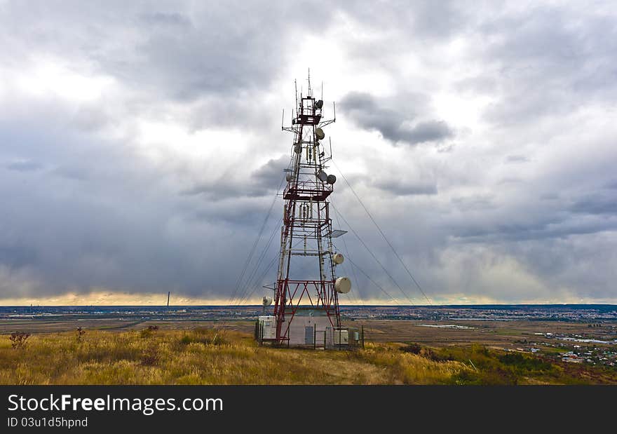 Communications tower above the city landscape