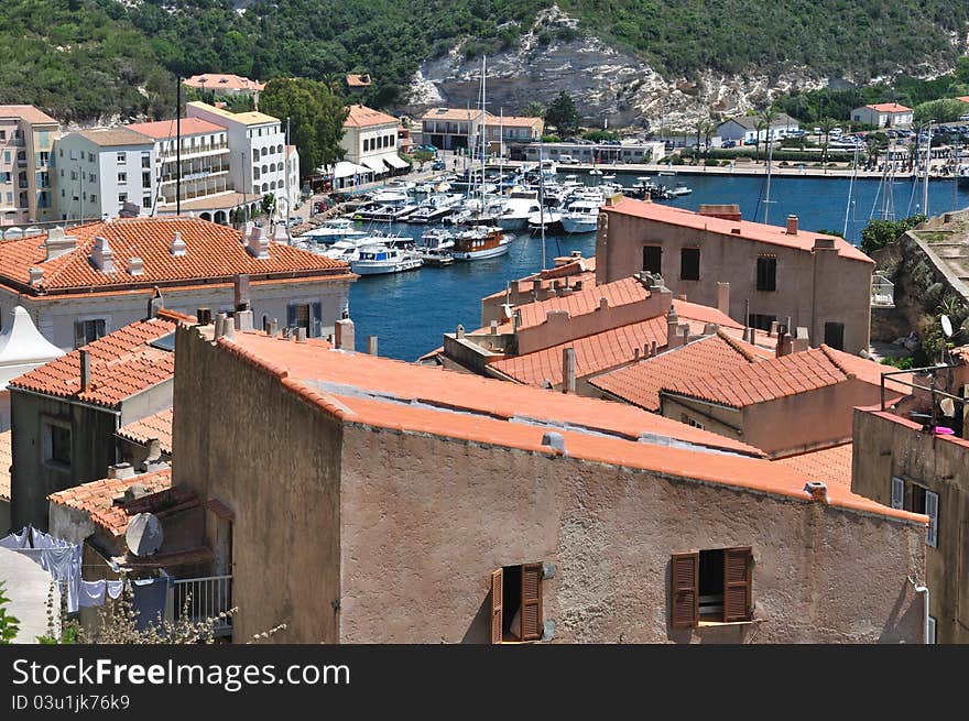 Marina in the hollow of a bay surrounded by houses and buildings. Marina in the hollow of a bay surrounded by houses and buildings