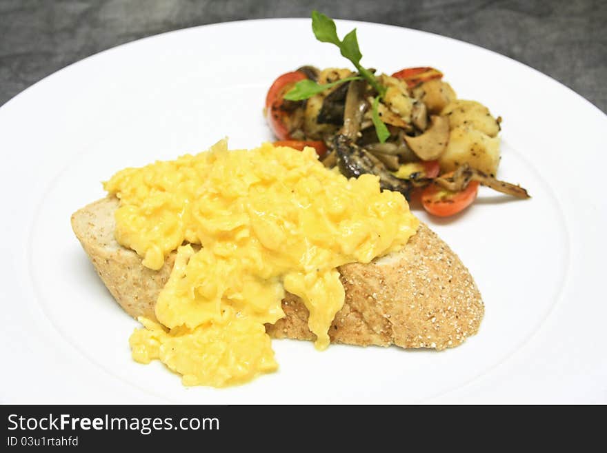 Raw eggs with salt and pepper stirred on top some bread. Raw eggs with salt and pepper stirred on top some bread