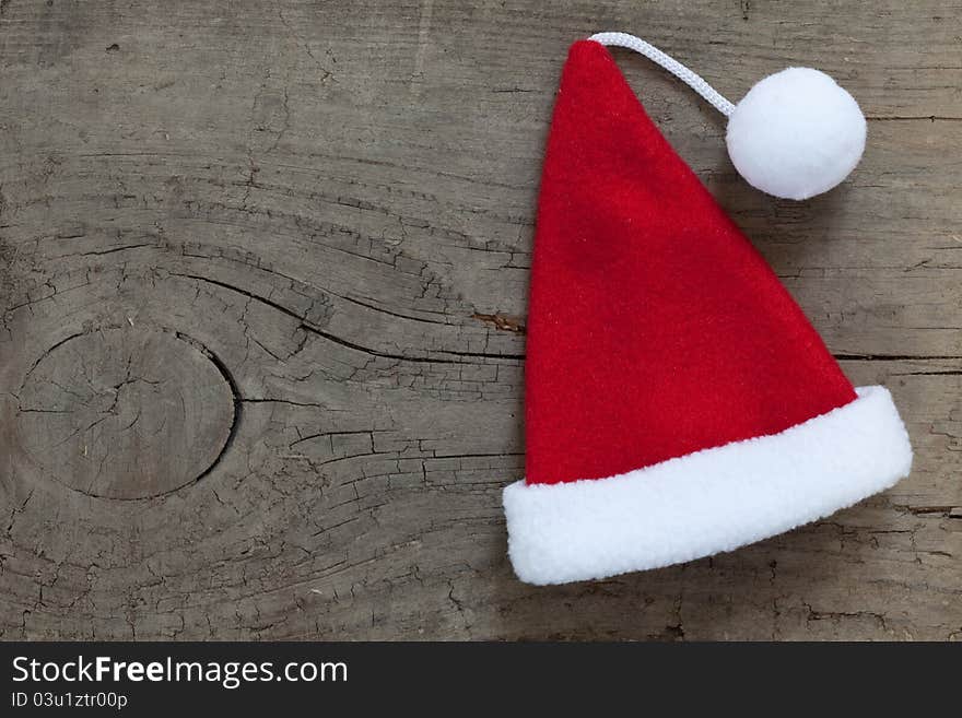 Santa hat on wooden background with copy space