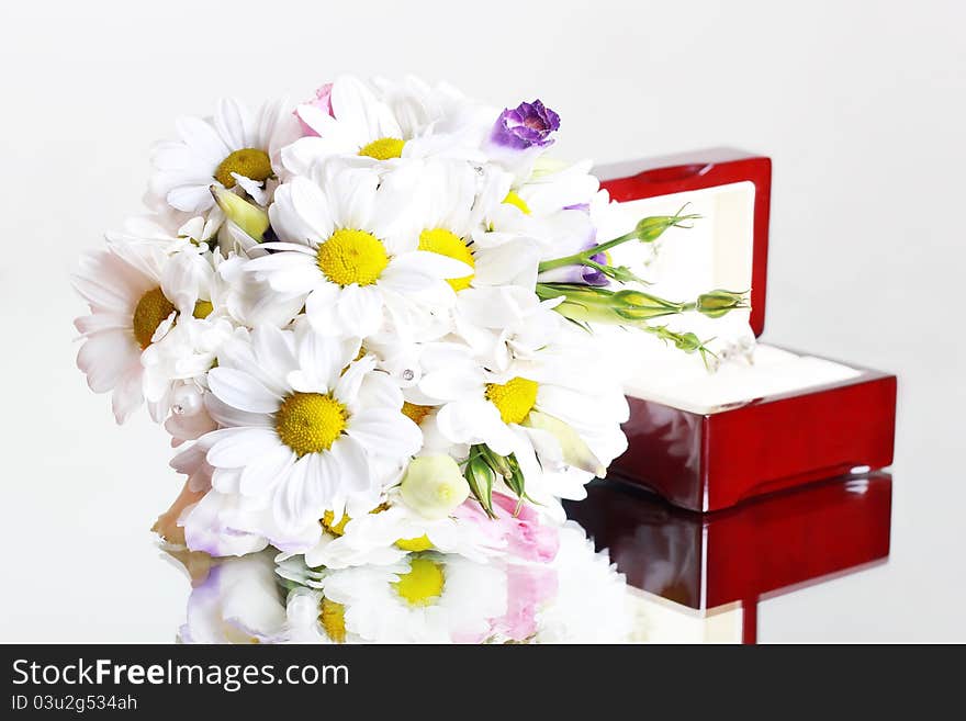 Bridal bouquet of daisies and a box with a ring. Bridal bouquet of daisies and a box with a ring