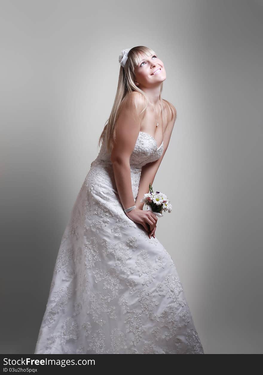 Beautiful young woman in a white dress with a bouquet of flowers. Beautiful young woman in a white dress with a bouquet of flowers