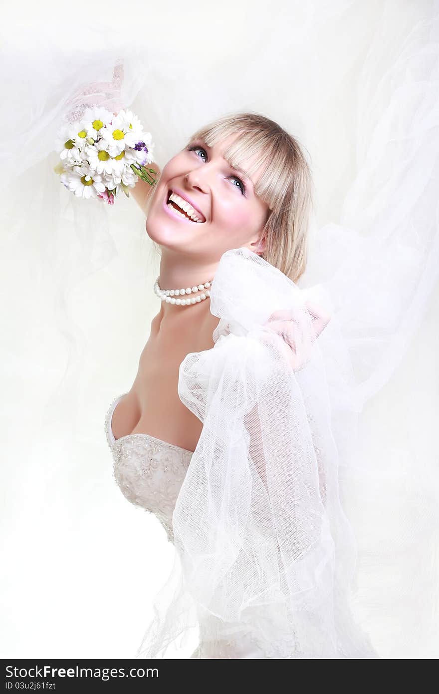 Beautiful young woman in a white dress with a bouquet of flowers. Beautiful young woman in a white dress with a bouquet of flowers