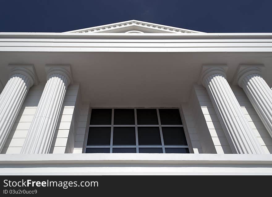 Close-up of classic columns against blue sky. Close-up of classic columns against blue sky