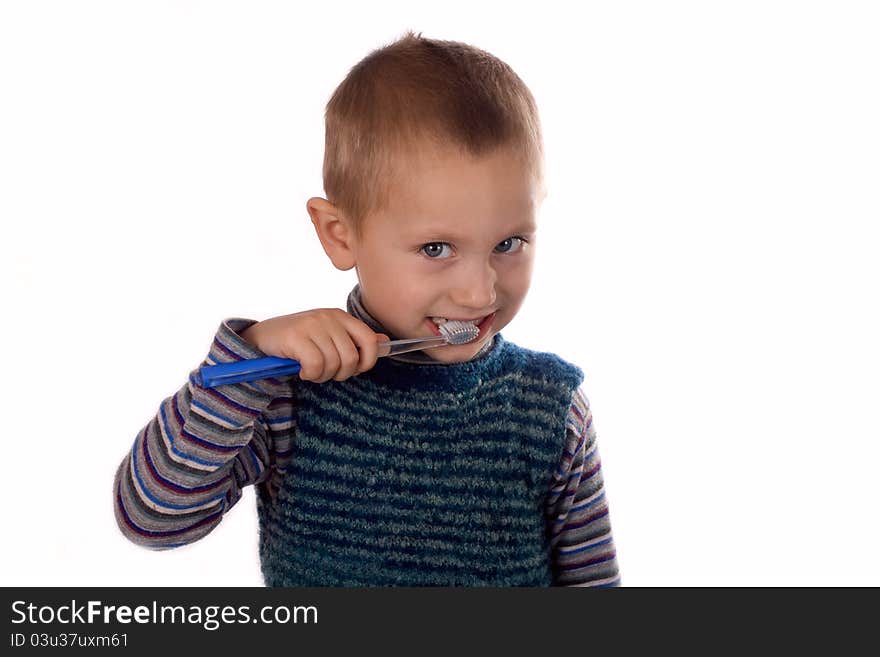 Boy brushing his teeth after bath