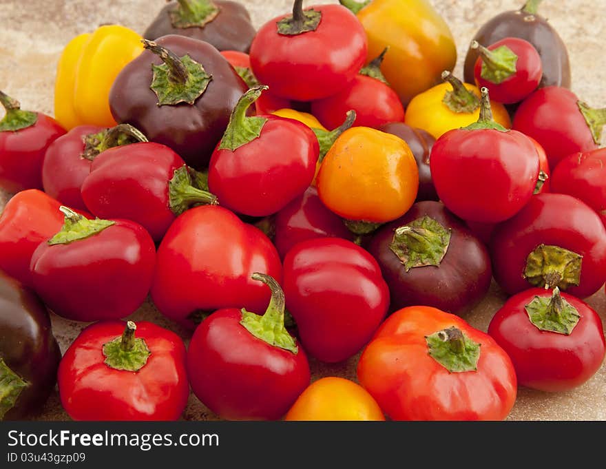 Miniature sweet peppers photographed on kitchen counter surface