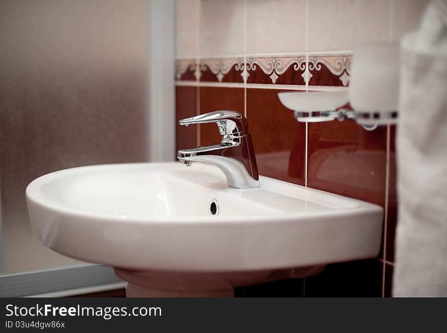 White sink with mixer tap in a beautiful bathroom. White sink with mixer tap in a beautiful bathroom