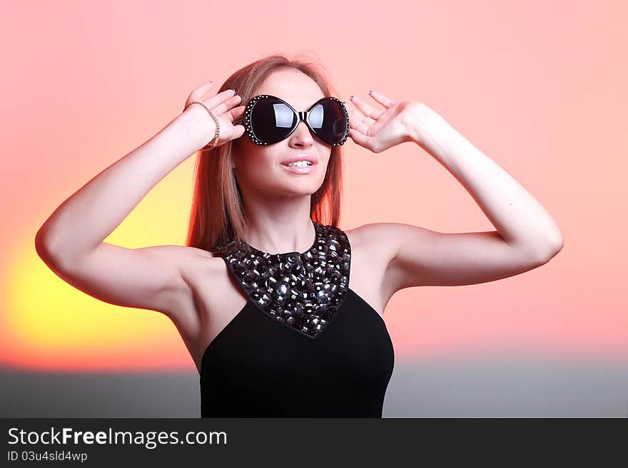 Beautiful young woman in stylish sunglasses on color background. Beautiful young woman in stylish sunglasses on color background