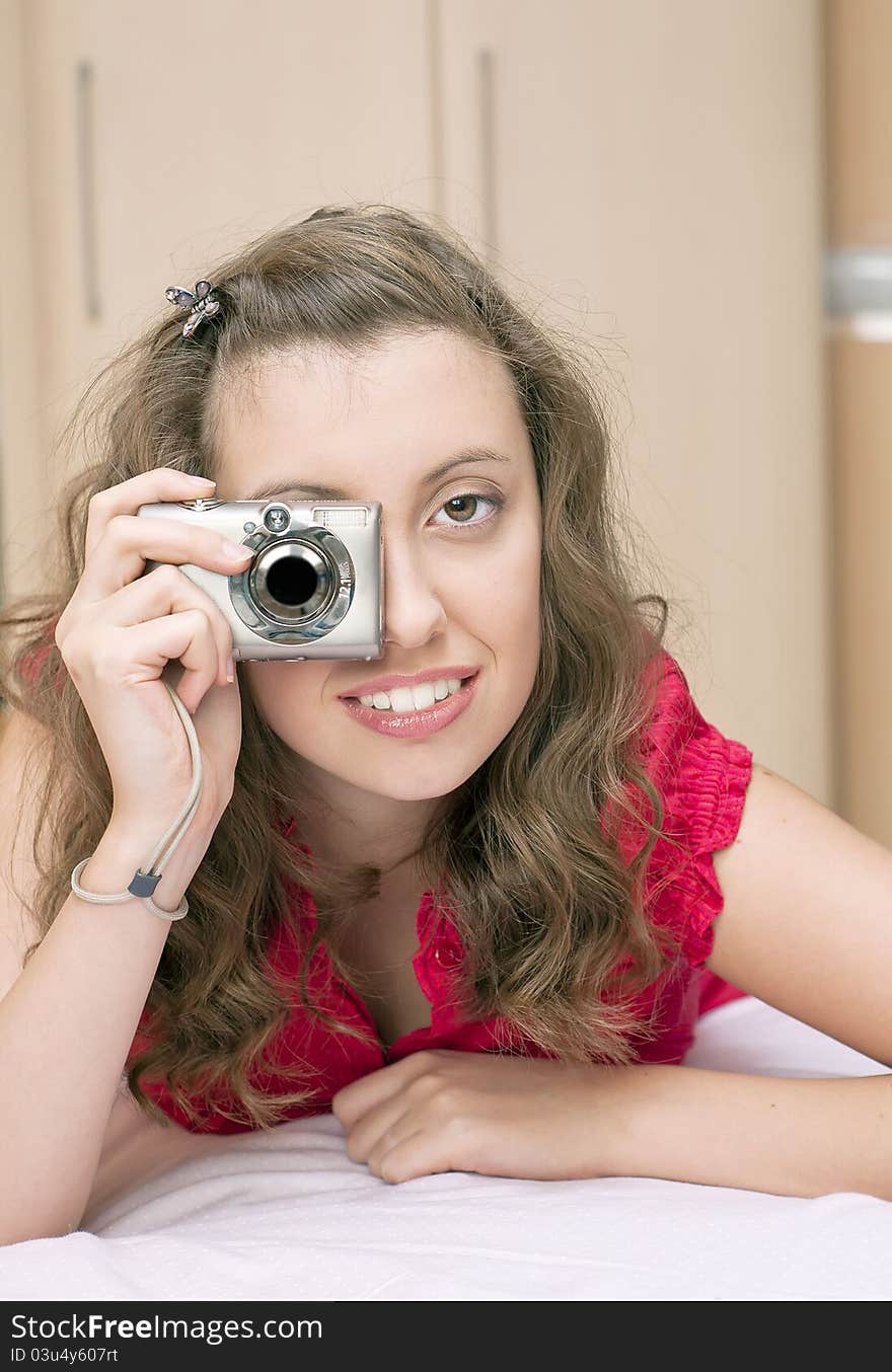 Young pretty girl with digital camera