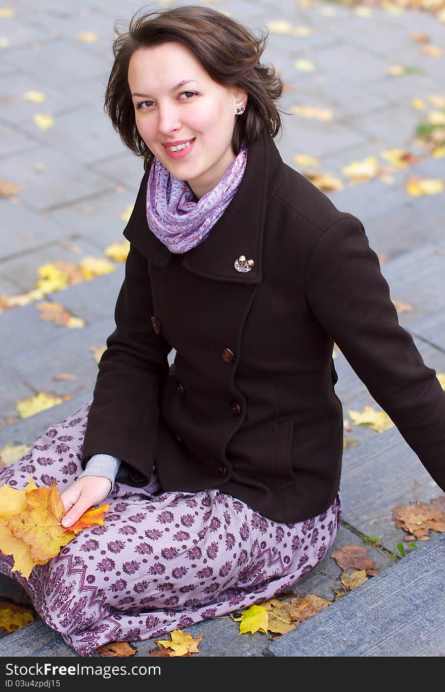 Lovely Smiling Woman With Autumn Leaves