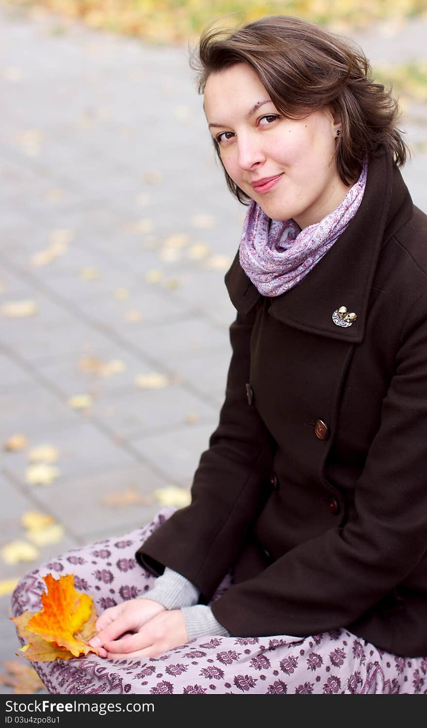 Lovely woman with autumn leaves