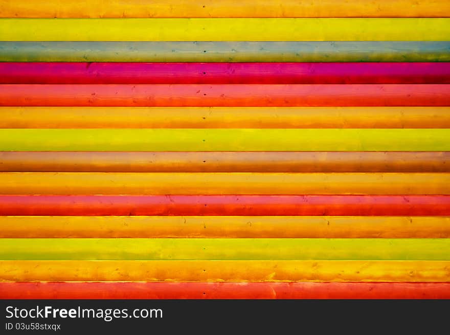 A creative multicolored wooden wall as a background. A creative multicolored wooden wall as a background