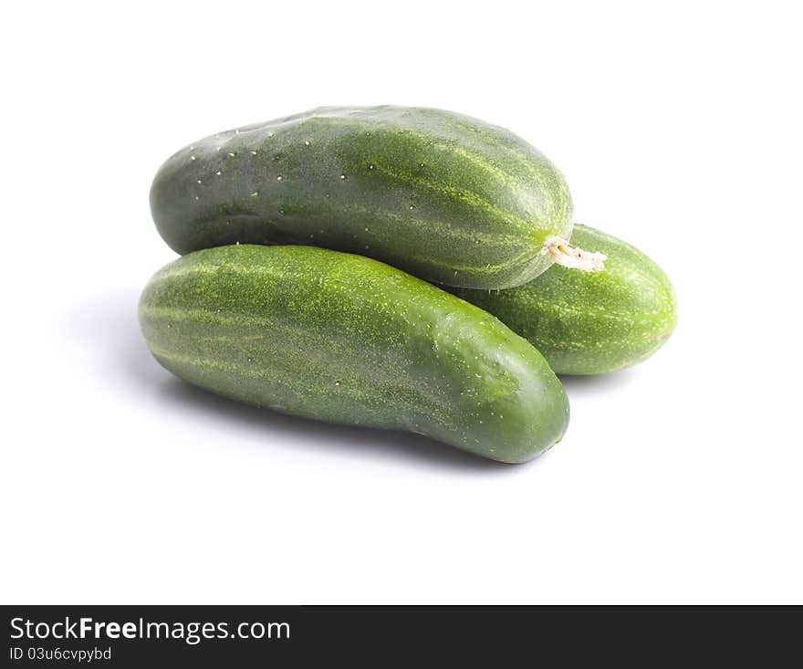 Three green cucumber  on white