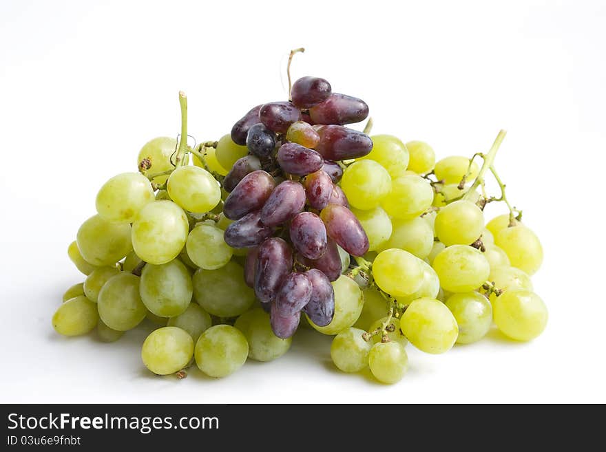 Green and red grapes  in a white background.