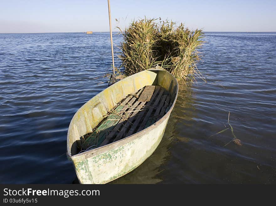 Old hunter boat on summer lake bank. Old hunter boat on summer lake bank