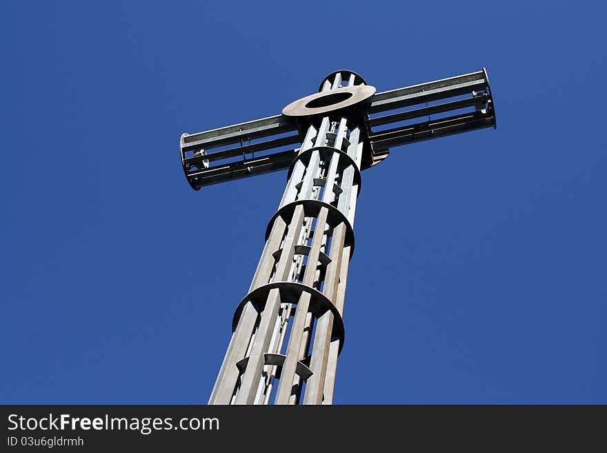 A massive metal cross on a sunny day