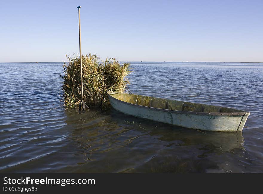 Old hunter boat on summer lake bank. Old hunter boat on summer lake bank