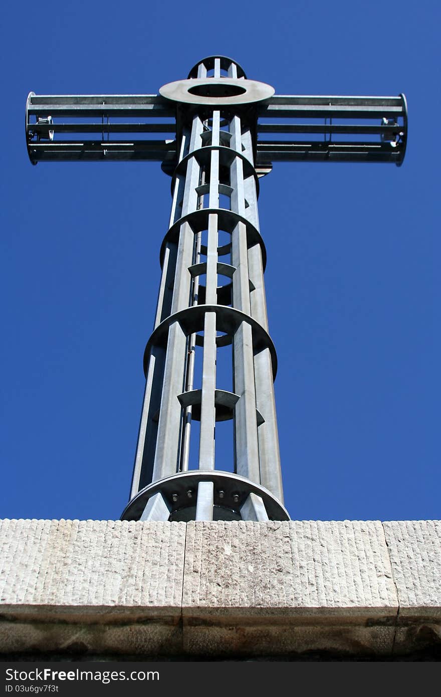 A massive metal cross on a sunny day