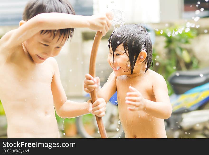 Asian Brother and sister take a shower outdoor