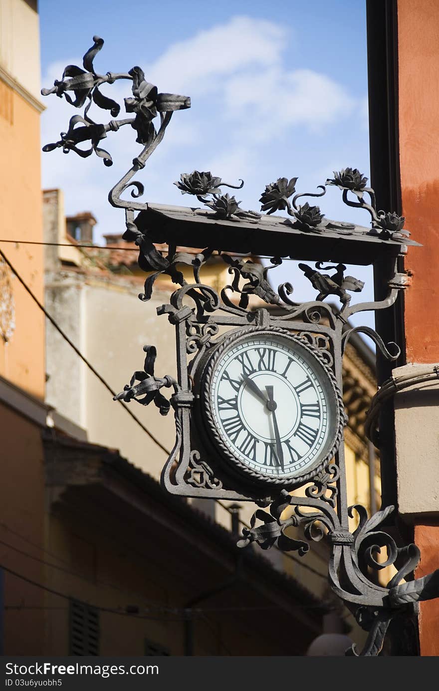 Artistic clock on a building in Bologna, Italy