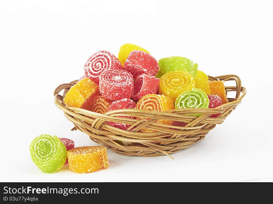 Colorful candy in bowl on white background.