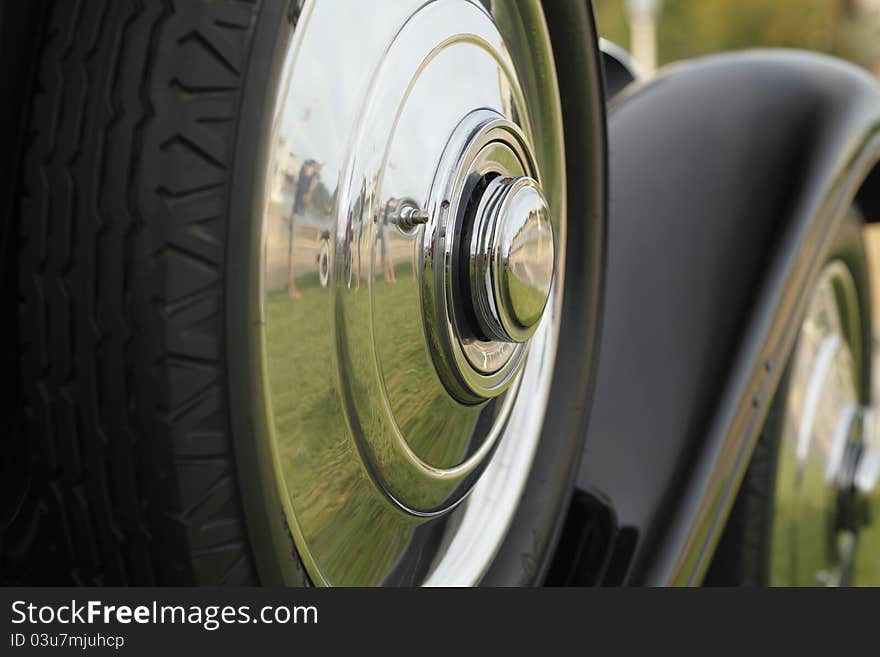 Classic Automobile Wheels with a reflection of a person taking a picture