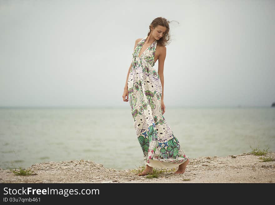 Young girl walking along the beach