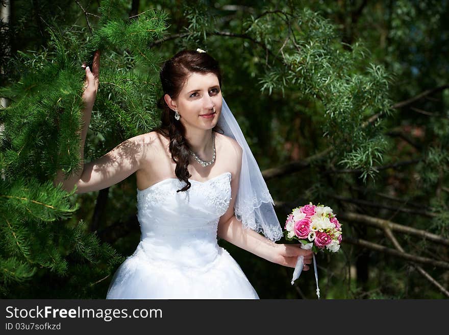 Happy bride with bouquet in wedding walk