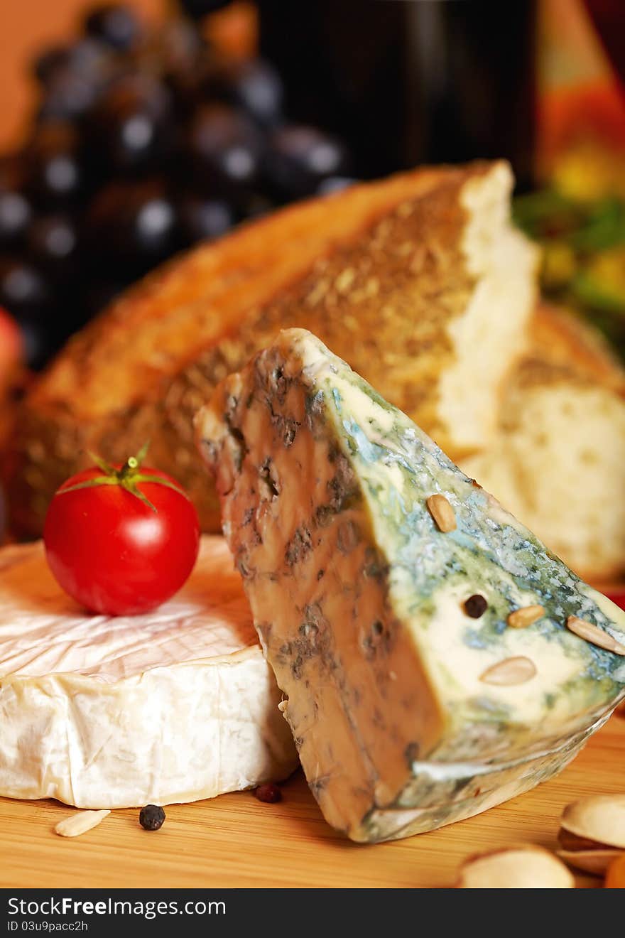 Still life with cheese and autumn fruits