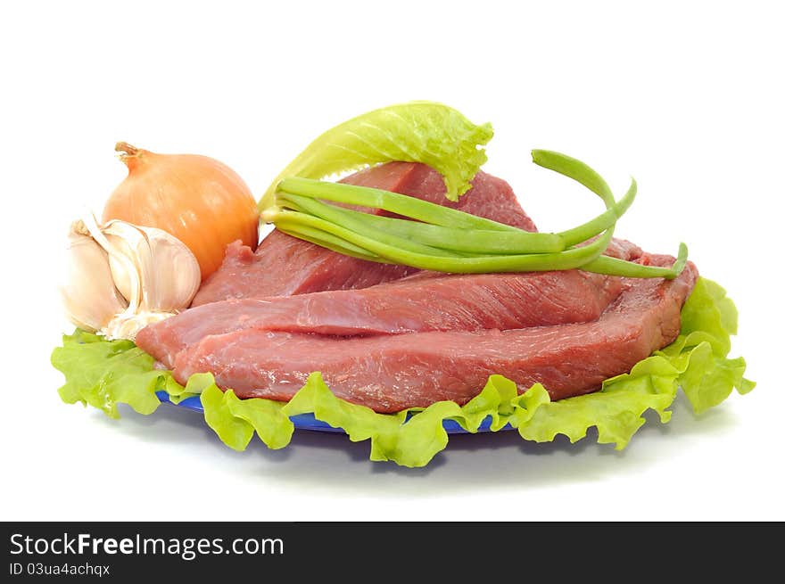 Fresh raw meat with some spice on a plate , on white a white background. Fresh raw meat with some spice on a plate , on white a white background