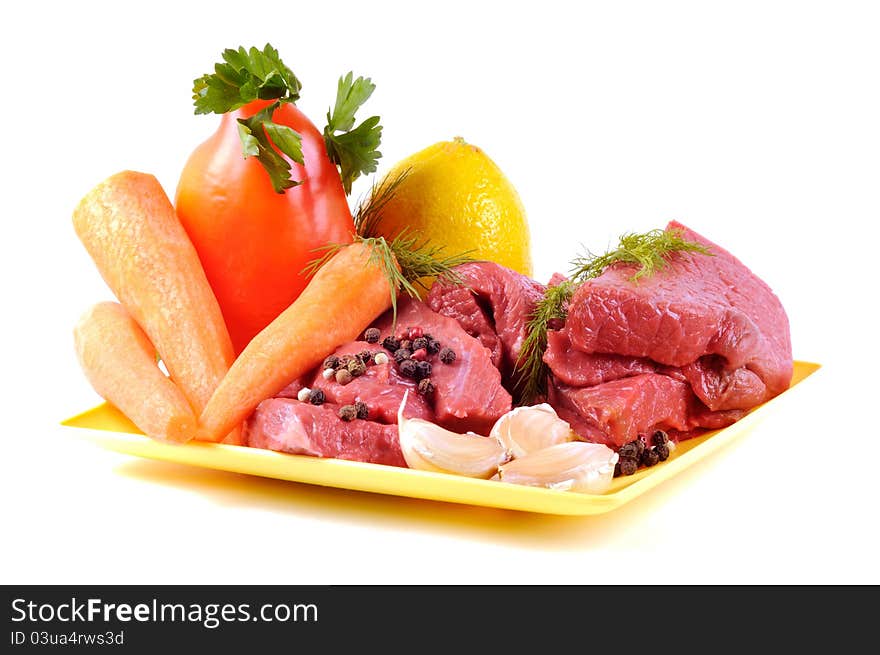 Vegetables some spices and raw meat , on a white background. Vegetables some spices and raw meat , on a white background