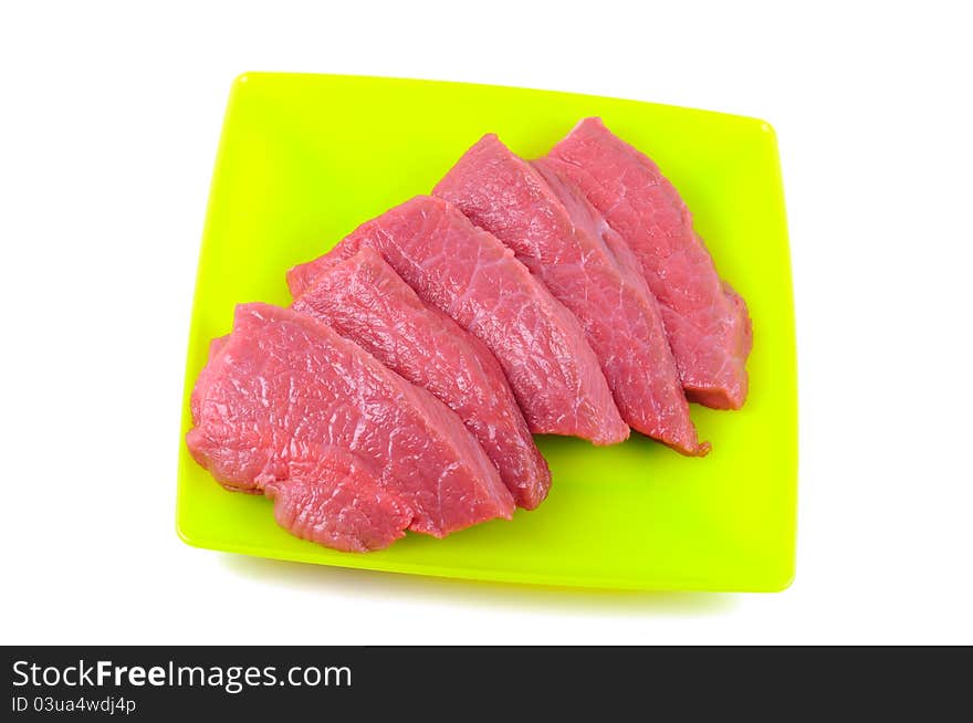 Fresh raw meat on a plate, on a white background