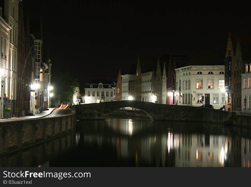 View of some ancient houses and a canal with a bridge in the historical town of Brugge in Belgium. View of some ancient houses and a canal with a bridge in the historical town of Brugge in Belgium.