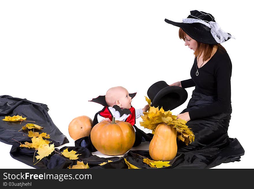 Halloween baby with mother near pumpking