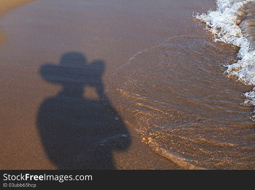 Shadow of man on the beach.