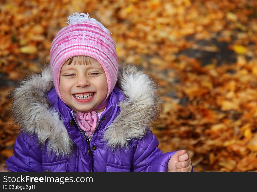 Happiness child smiling in the autumn park. Happiness child smiling in the autumn park