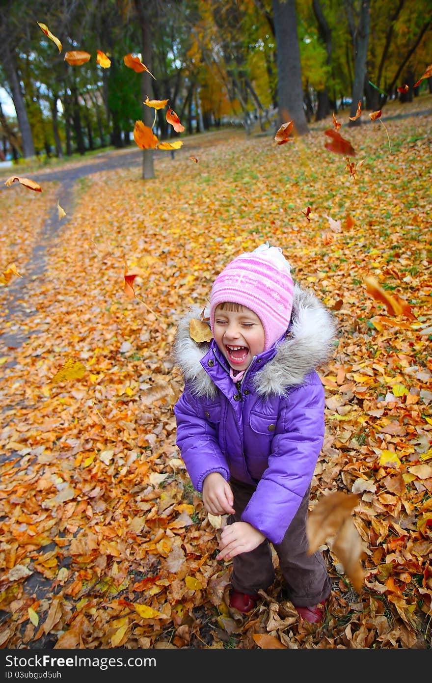 Happiness child smiling in the autumn park. Happiness child smiling in the autumn park