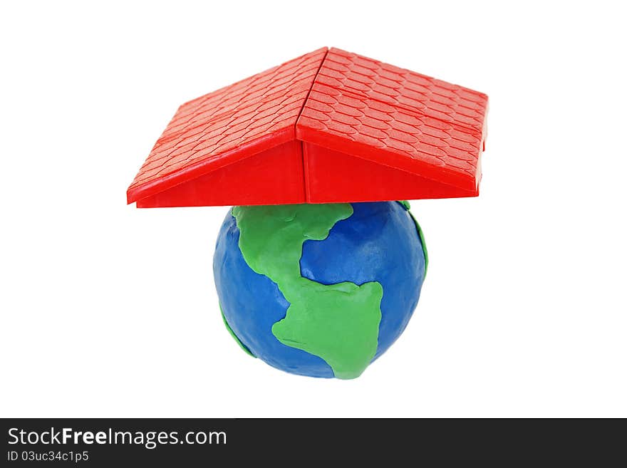 The red plastic roof and a plasticine globe on white background. The red plastic roof and a plasticine globe on white background