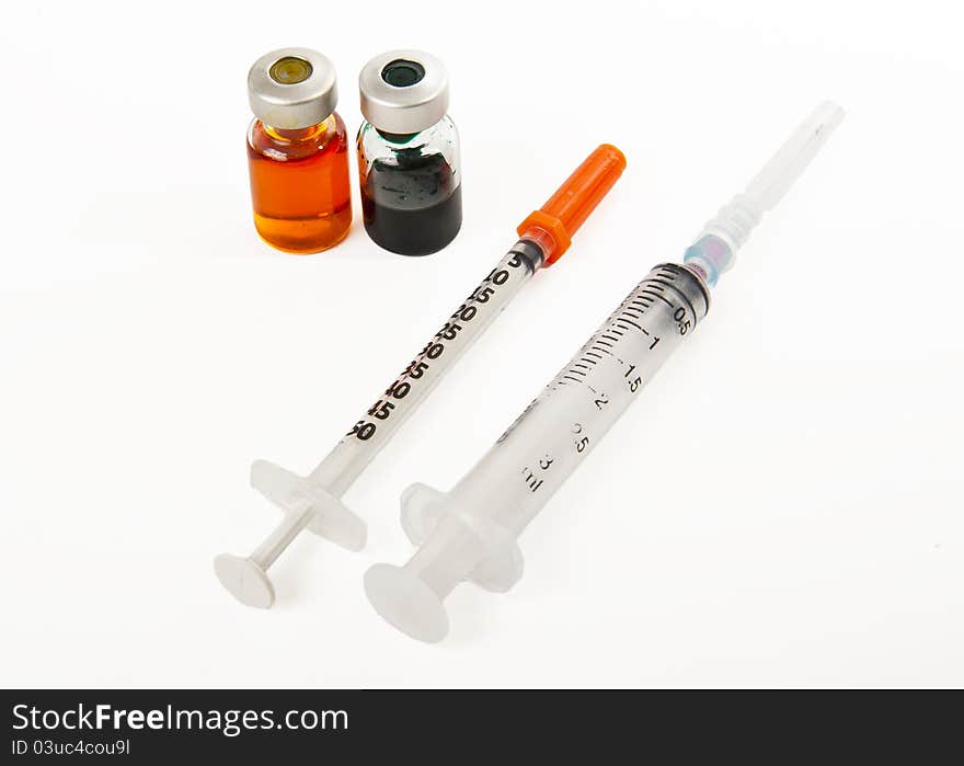 Two Syringes And Two Bottles Of Medicine