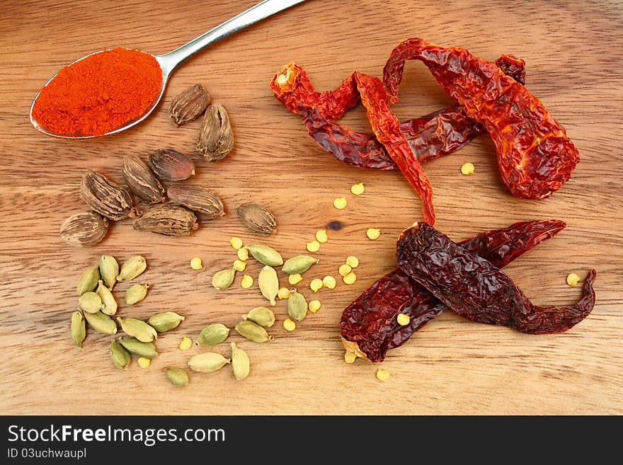 Dried chillies, chilli seeds, whole black and green cardamoms and chilli powder. Dried chillies, chilli seeds, whole black and green cardamoms and chilli powder.