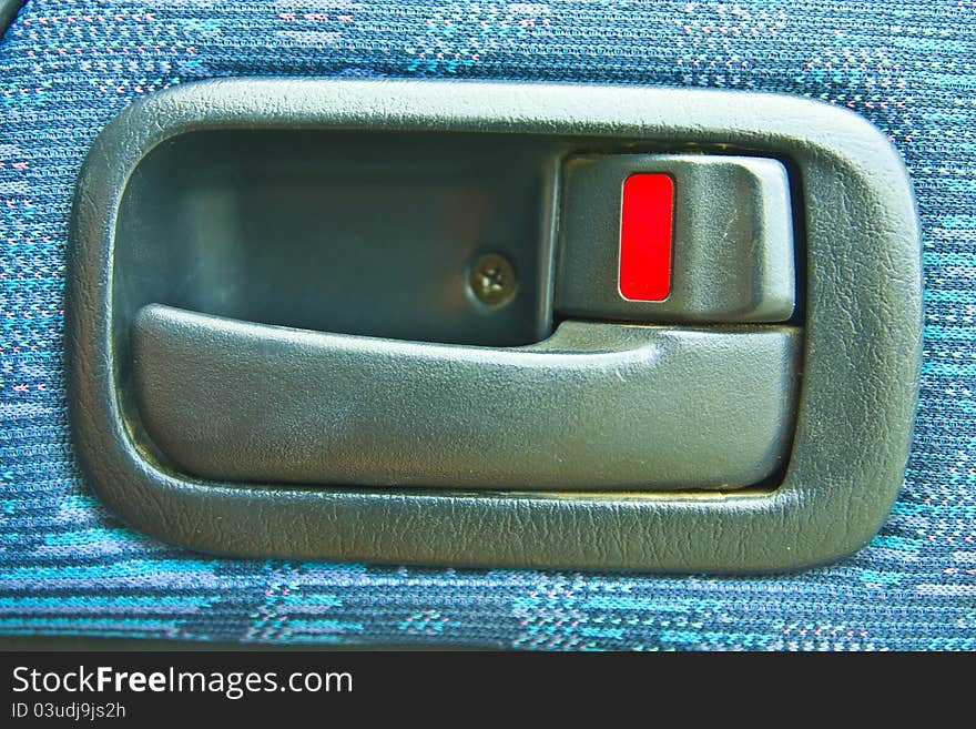 Blue handle of the door of a car