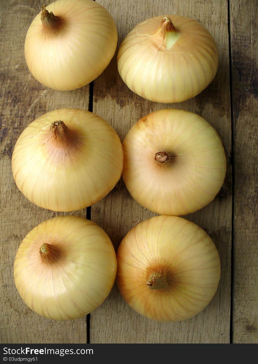 Onions on a wooden background