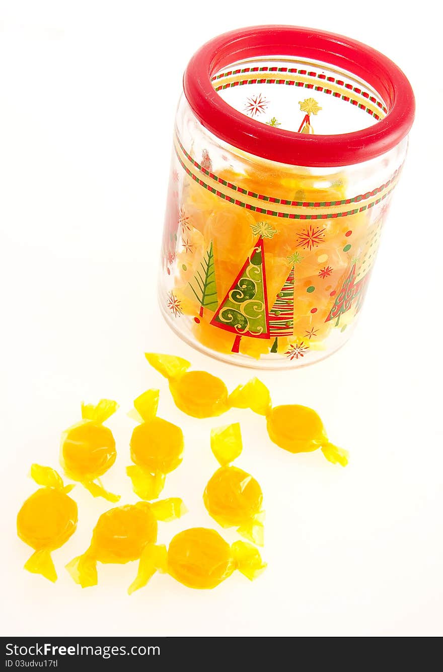 Foil wrapped yellow candies in jar